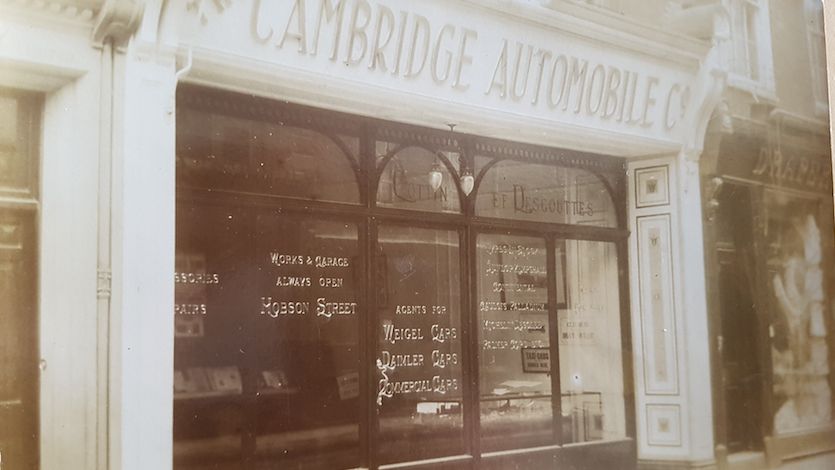 Cambridge Automobile Company shop window on Hobson Street with messages on the window saying Works and Garage Always Open