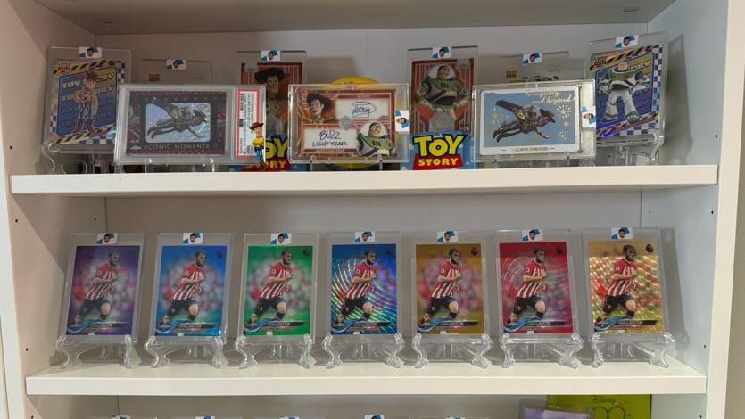 Football and Toy Story cards on a shelf
