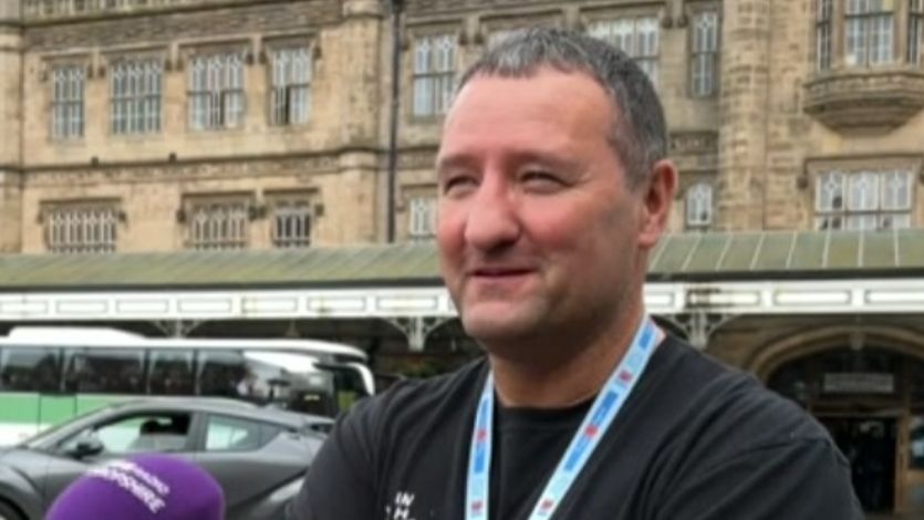 Roddy Doran in a dark grey top in front of Shrewsbury train station