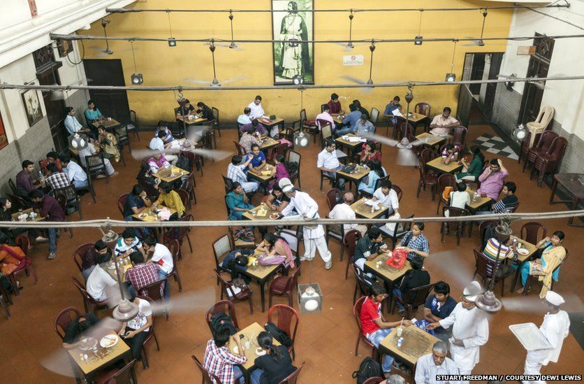 Customers sit beneath a portrait of Rabindranath Tagore in the Indian Coffee House, Kolkata, India