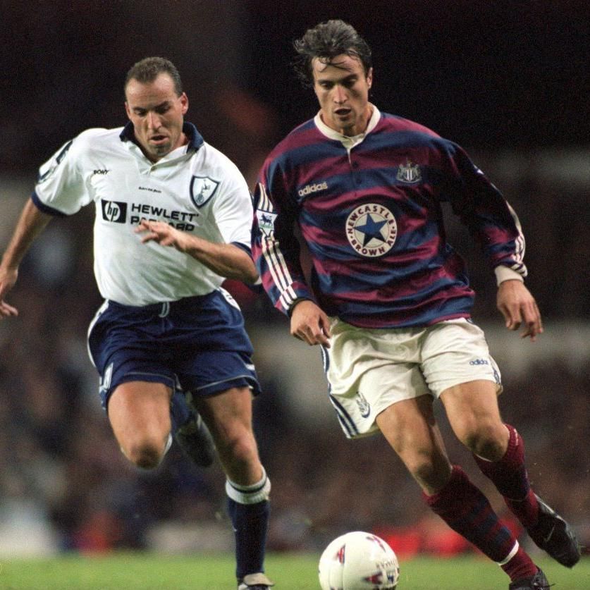 Newcastle's David Ginola wearing the club's blue-and-burgundy away shirt against Tottenham