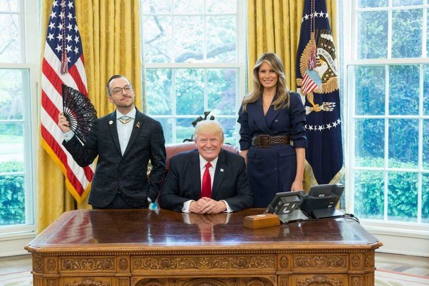 Nikos Giannopoulos with Donald and Melania Trump. and a flag