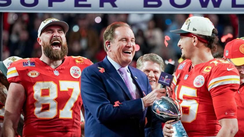 Travis Kelce and Patrick Mahomes being presented with the Super Bowl trophy in 2024