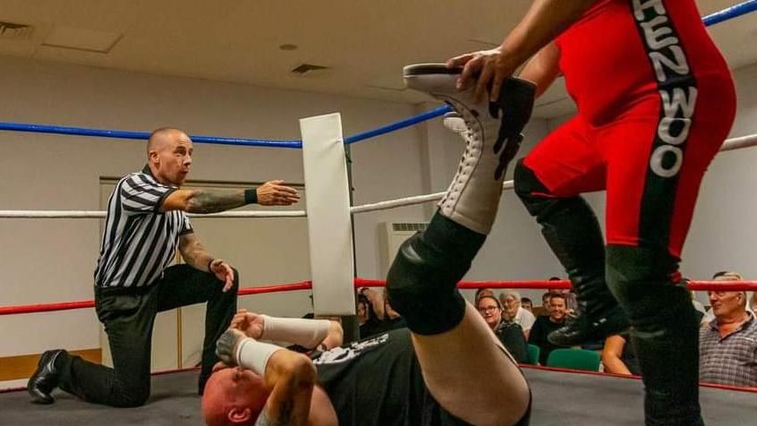 Steven Horne refereeing a wrestling match