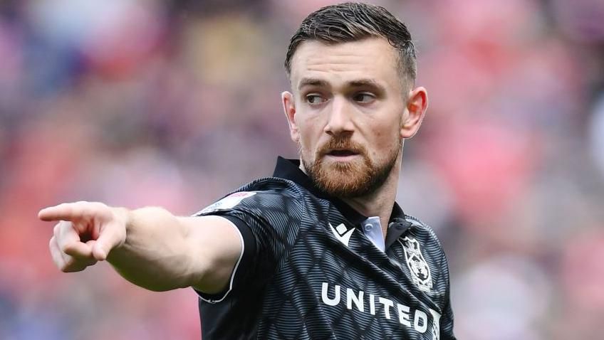 Jack Marriott points during a Wrexham game