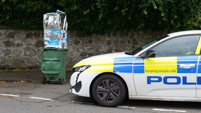 bin with ATM and police car