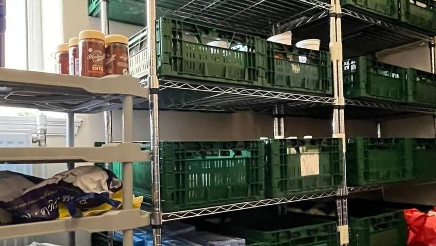 Picture of crates of food in green crates on shelves 