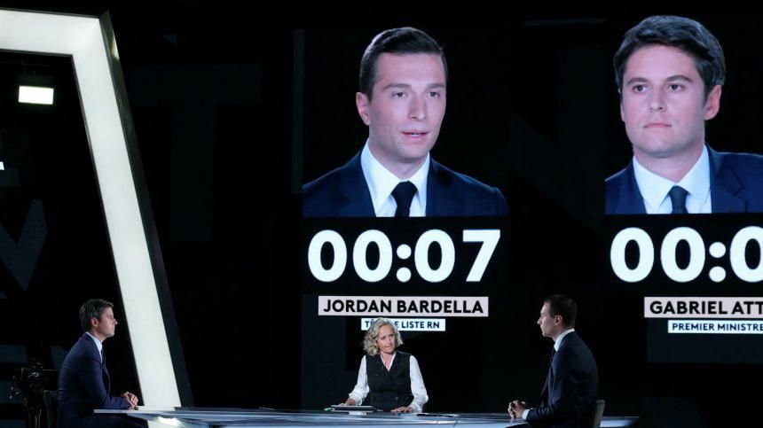 French far-right Rassemblement National (RN) party's President and leading candidate for the June 9 European union election Jordan Bardella (L) and France's Prime Minister Gabriel Attal attend a debate 