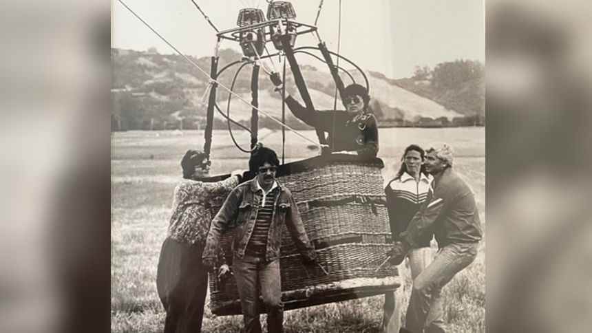 A black and white photo of Chenube in a balloon with a small crowd nearby