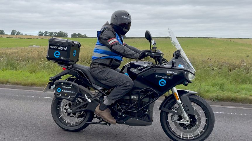 A helmeted rider on a Zero electric motorcycle