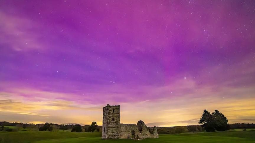 The northern lights above Knowlton Church in Dorset