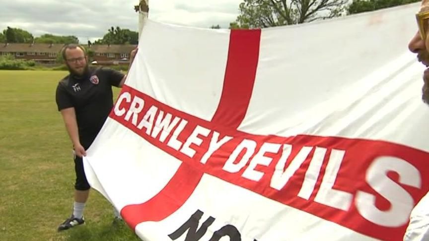 Freddie Hahn unfurling his large England flag