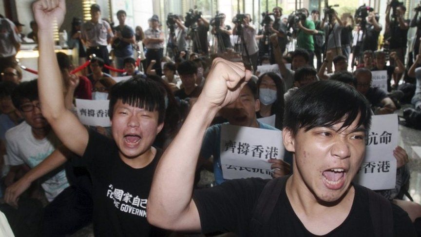 Hong Kong and Taiwanese student demonstrators shout slogans in support of pro-democracy protests taking place in Hong Kong at the Hong Kong Economic, Trade and Cultural Office in Taipei, Taiwan, Monday, 29 Sept, 2014.