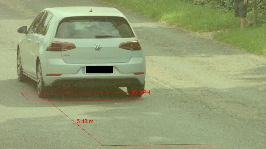 Speed camera capture photo annotated with the car's speed