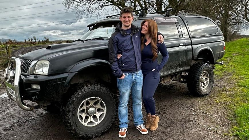 Ed and Katie standing in front of a similar vehicle