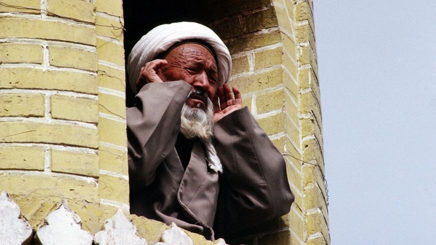 A Muslim man leads the call to prayer in Kashgar, in China's Xinjiang province