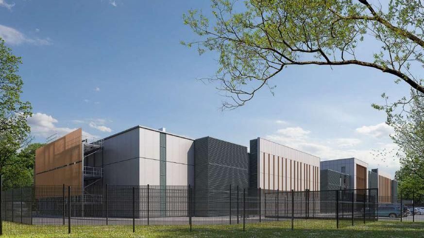 A computer generated image shows plans for the extension to the data centre. The image shows several rectangular buildings surrounded by a black fence.