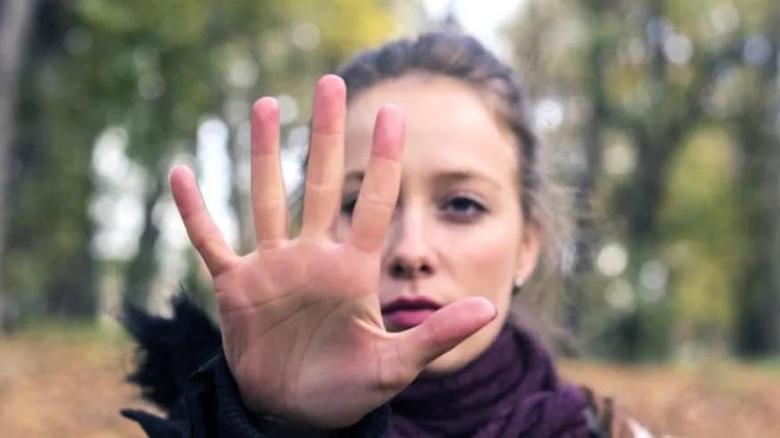 Woman raising hand to stop