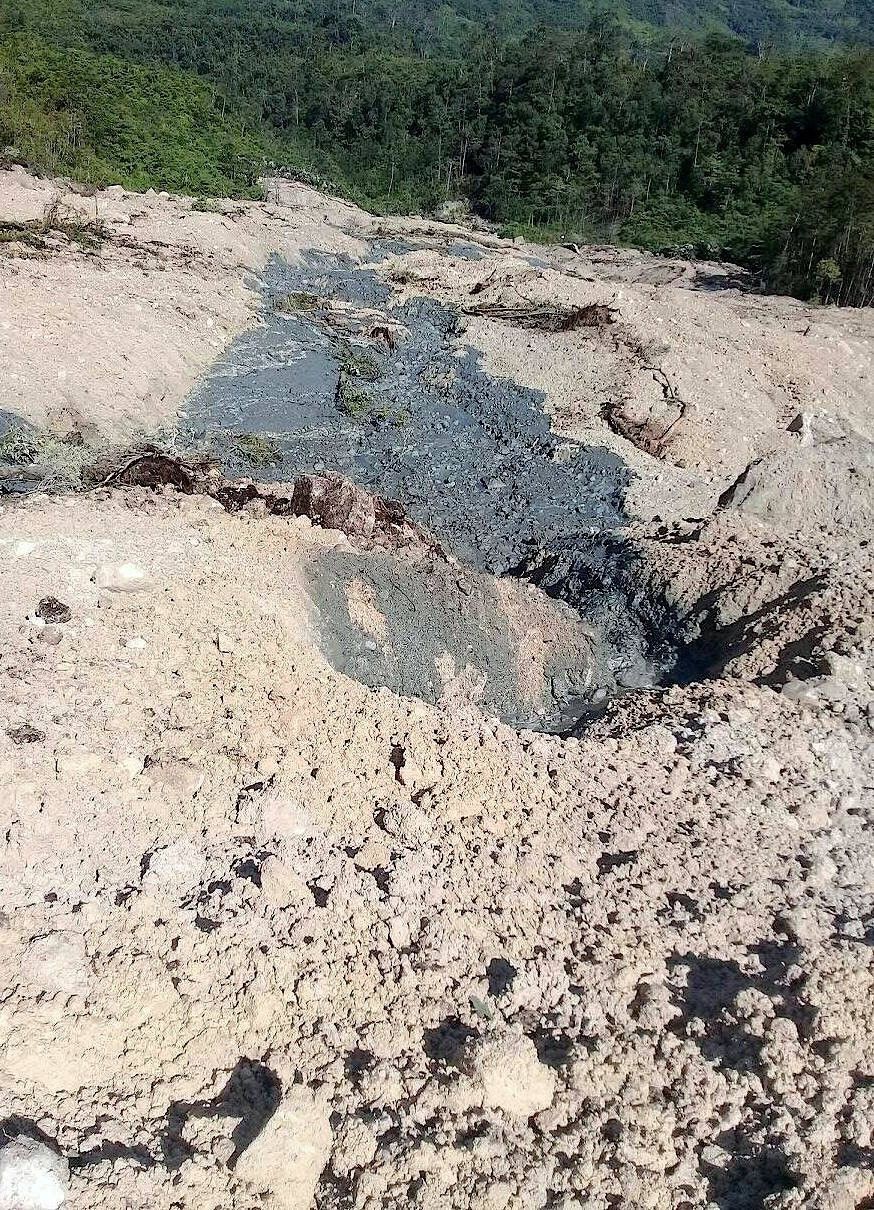 A handout photo shows a landslide and damage to a road located near the township of Tabubil after an earthquake that struck Papua New Guinea's Southern Highlands