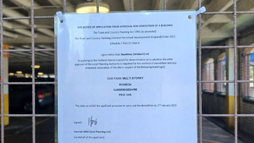 A notice in the car park informing permission for demolition is being sought 