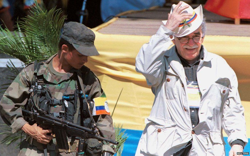 Gabriel Garcia Marquez (R) walks alongside a leftist rebel during the opening of the peace talks, 7 January 1999 in San Vicente del Caguan, southeast Colombia, that has been cleared of government troops for the talks.