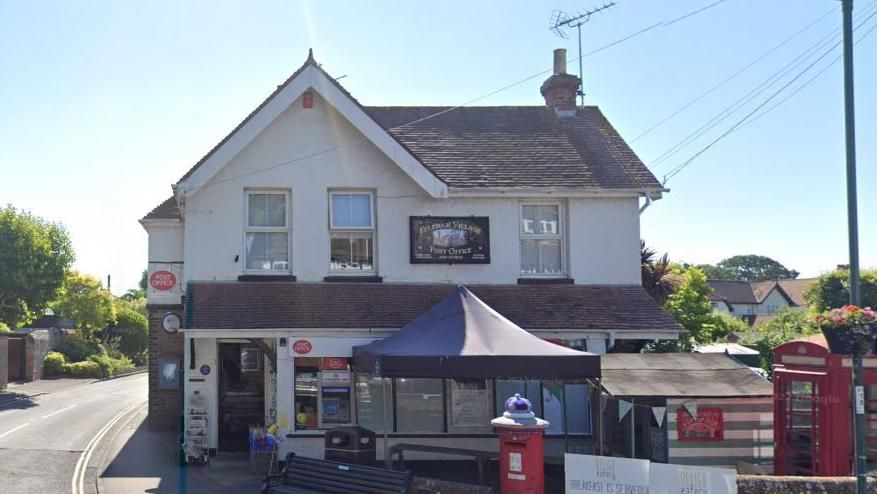 A Google maps image of Felpham Post Office, a white building displaying red Post Office signs on the corner of a junction 