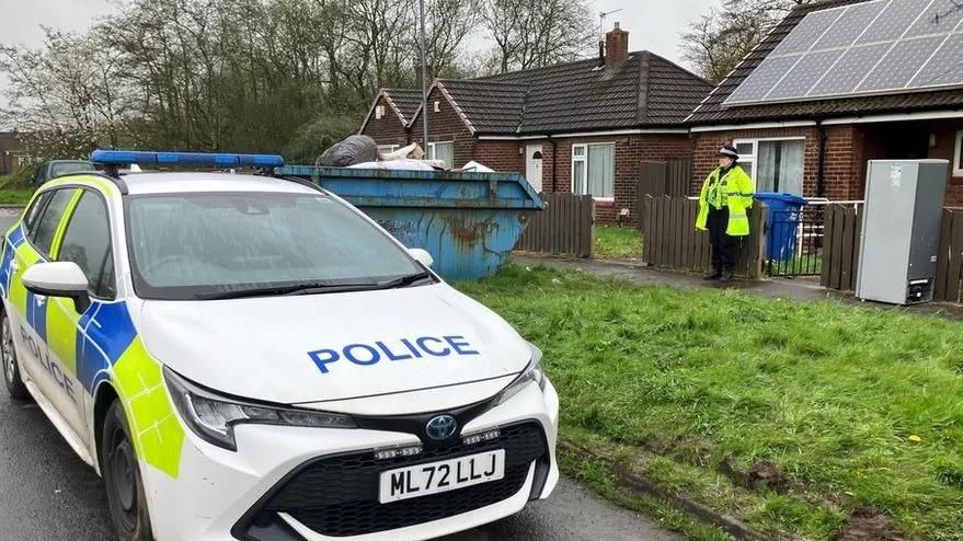 Police car outside home in Wigan where baby remains were discovered