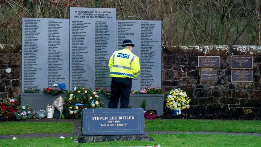 A police officer at a ceremony to mark the 35th anniversary of the Lockerbie bombing at the Memorial Garden, Dryfesdale Cemetery, Lockerbie.