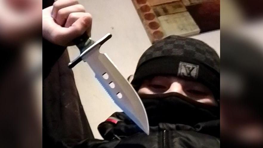 Jordan Rance holding a knife