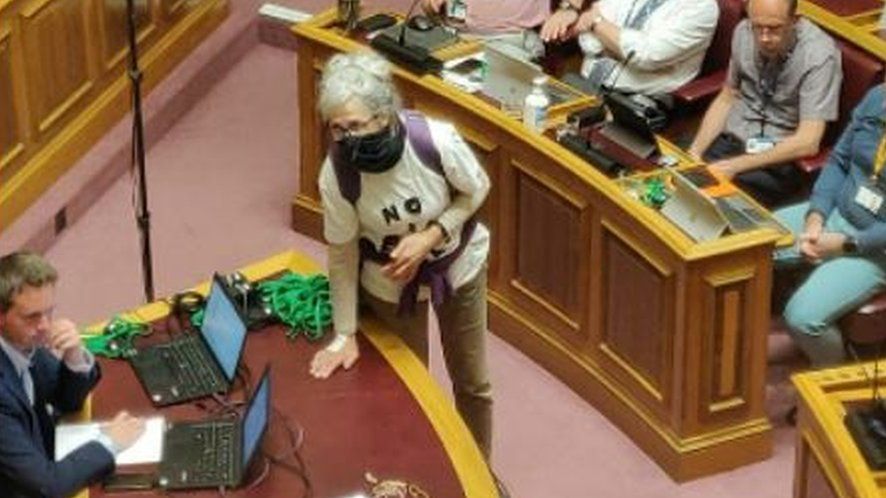 the two women with their hands on the desk