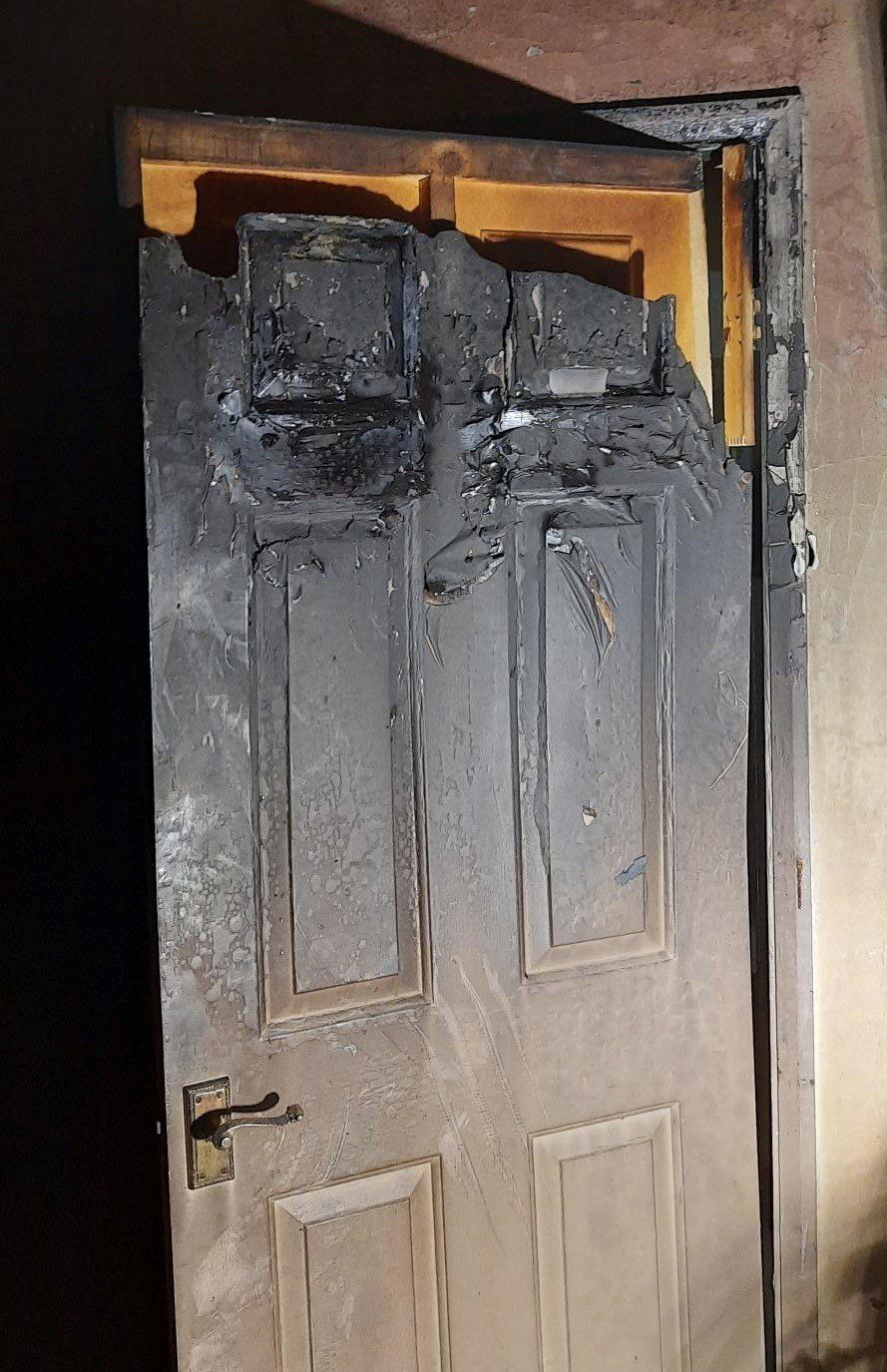 A door is partially melted by fire