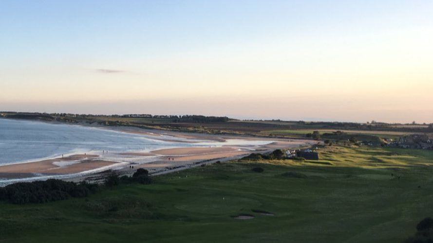 A panoramic view of Alnmouth golf club with the beach behind