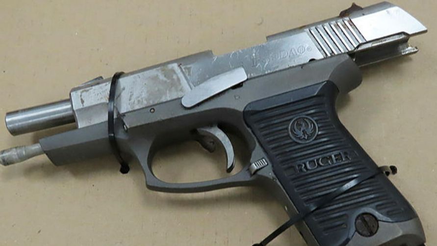 A silver semi-automatic handgun