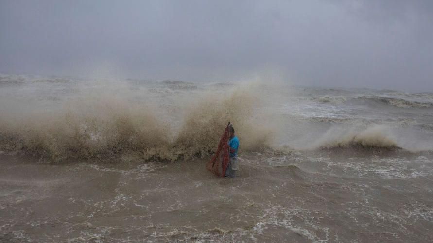 Fisherman in the sea following the landfall of Cyclone Remal in Bangladesh