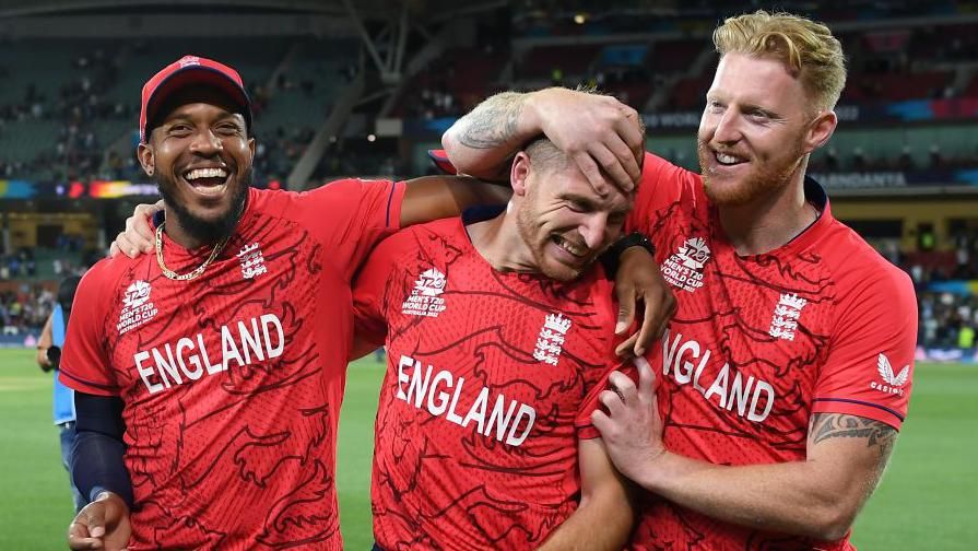 England players Chris Jordan (left), Jos Buttler (centre) and Ben Stokes (right) celebrate victory in the 2022 T20 World Cup semi-final against India