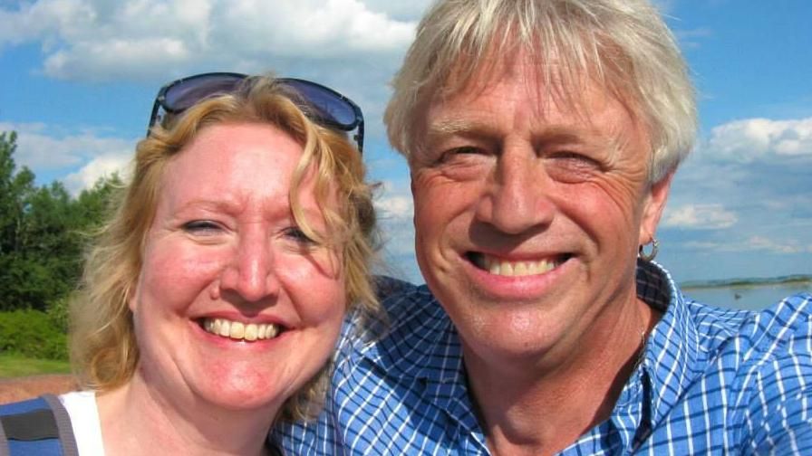 Sarah Packwood on the right, and her husband Brett Clibbery smile at the camera for a selfie