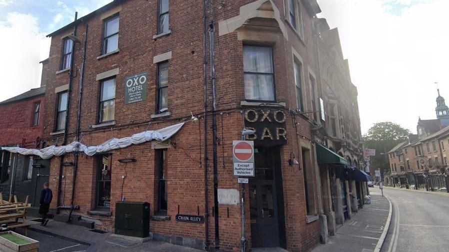 The OXO Hotel - a red brick building on the corner of a road 