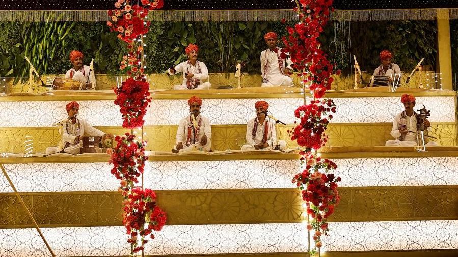 Folk musicians perform outside the home of businessman Mukesh Ambani ahead of his son Anant Ambani's wedding to Radhika Merchant in Mumbai, India, July 10, 2024