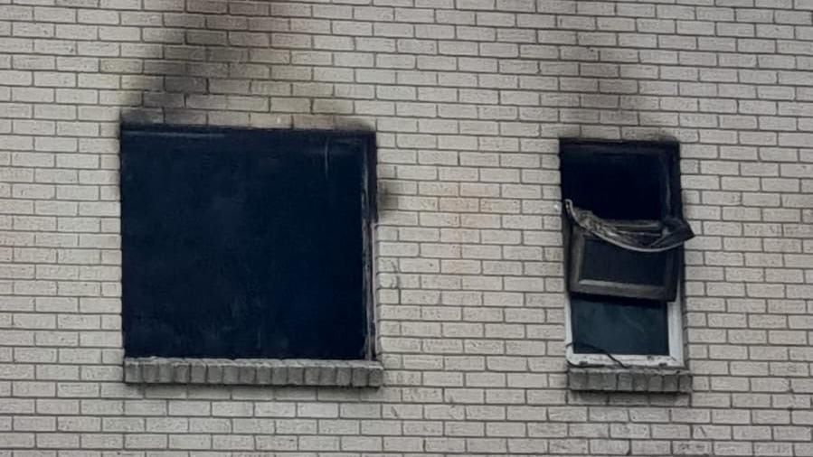 The burnt out windows of first floor flat can be seen in the images