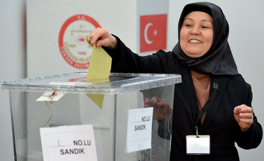 A woman casts her vote for the Turkish constitution referendum, in the Turkish consulate general in Cologne