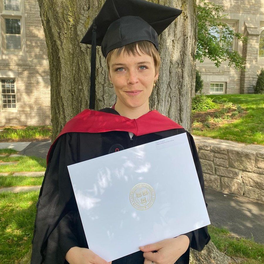 Maggie Rogers with her Masters degree
