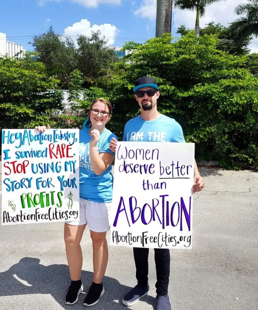 Two people protesting with signs