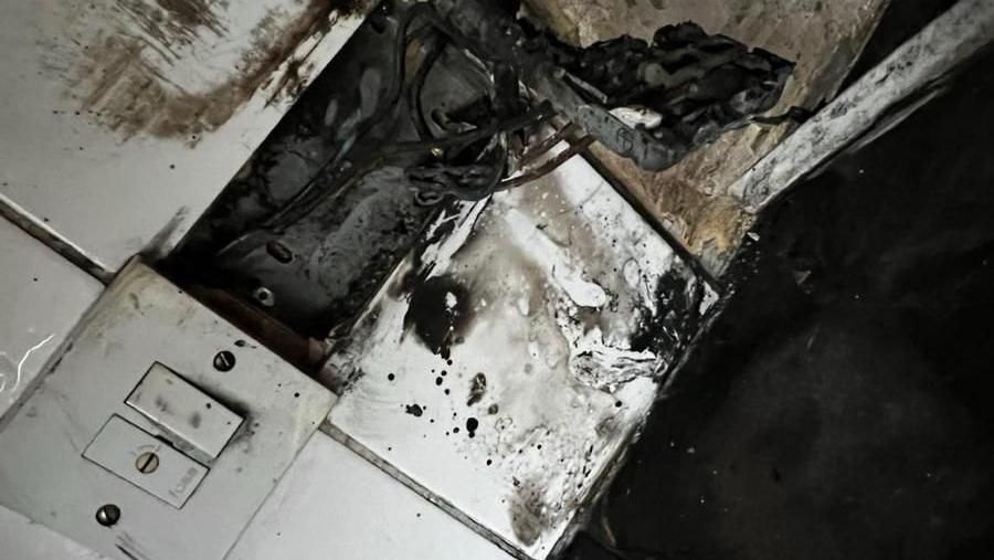 Charred remains in kitchen also showing a damaged plug socket