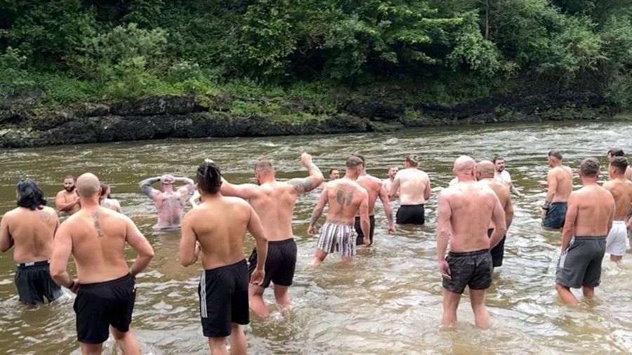 A group of men taking a dip in the River Severn