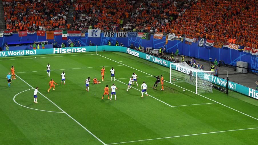 Netherlands player Denzel Dumfries is stood in an offside position, far right, next to France goalkeeper Mike Maignan.