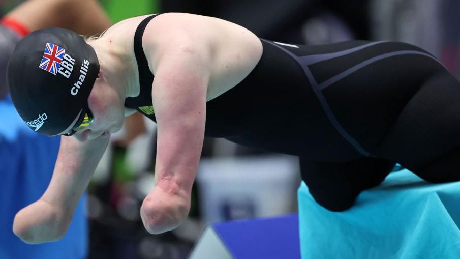 Britain's Ellie Challis dives into the pool