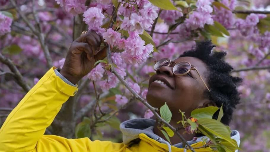 Woman sniffing flowers