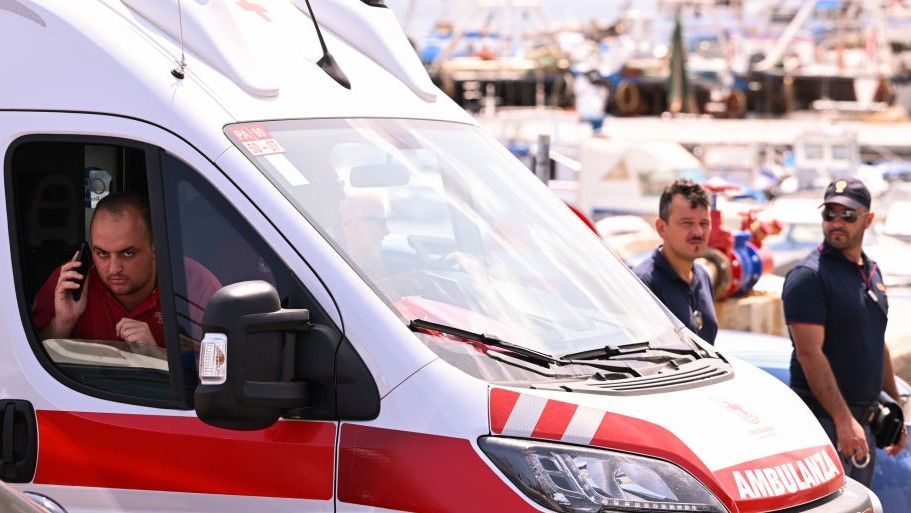  An ambulance is parked near the harbor where a search continues for missing passengers after a yacht capsized on August 19, 2024 off the coast of Palermo