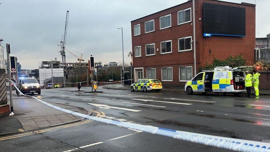 Three police vehicles inside a police cordon in Huntingdon Street in Nottingham City Centre after a fatal collision