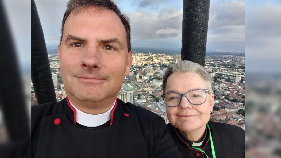 A selfie taken by Rev Neil Patterson and Very Rev Dr Mandy Ford on board the hot air balloon overlooking the city landscape